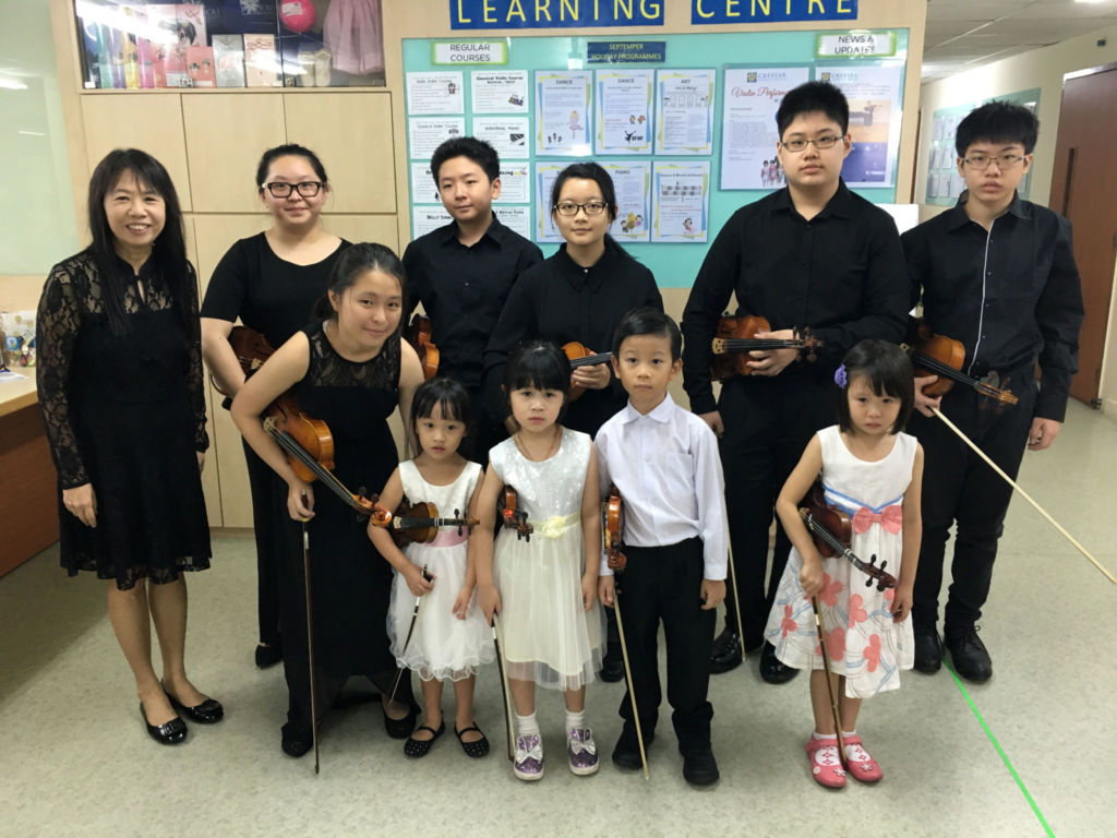 Violin teacher, Ms Kon (left) and her students from as young as 3 years old!